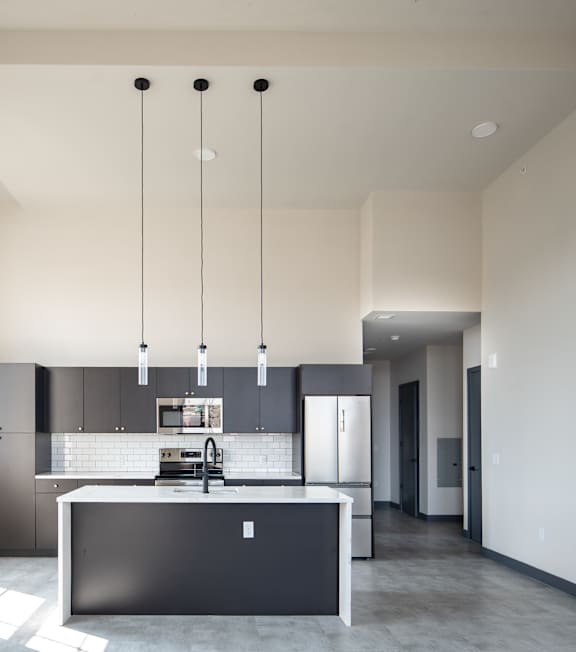 a kitchen with stainless steel appliances and wooden cabinets at The 55 Elm Club Apartments, Connecticut