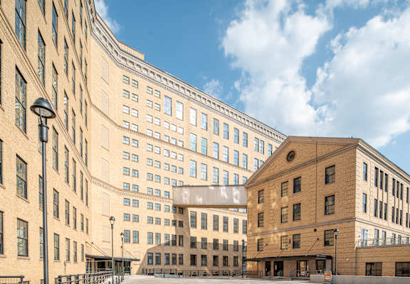 A modern building with a glass facade is situated between two older buildings. at The 55 Elm Club, Connecticut, 06106