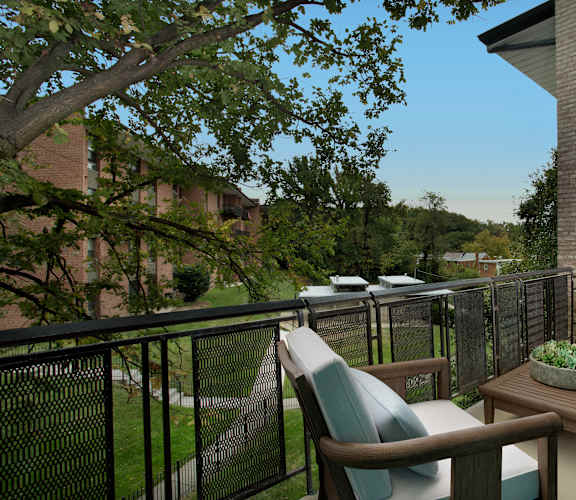 a porch with chairs and a table on a balcony
