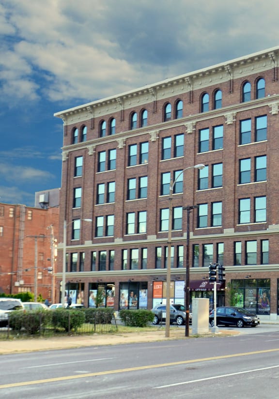 a large brick building on the corner of a city street
