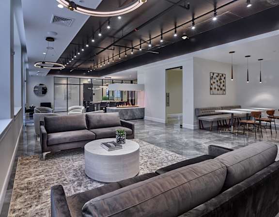 A modern living room with a grey sofa set and a coffee table.