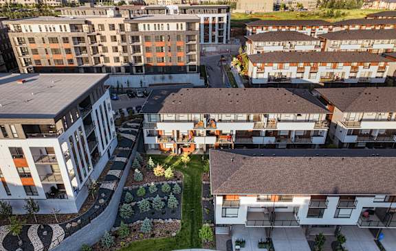 A balcony overlooks a road with cars and buildings in the distance.