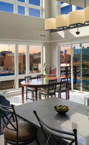 a living room with a table and chairs and a view of the city