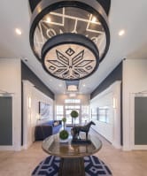 a lobby with a table and a large ceiling with a design on it