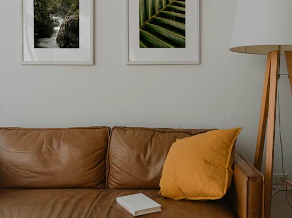 a living room with a couch and two pictures on the wall  at Pier Park Apartments, Oregon