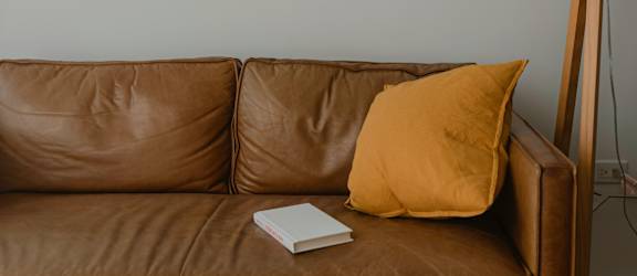 a living room with a couch and two pictures on the wall