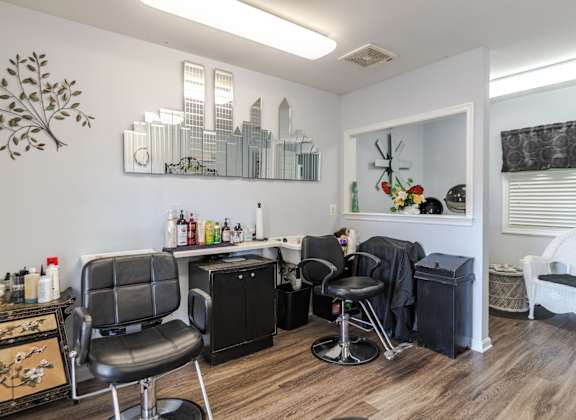 A room with a black chair and a white chair.