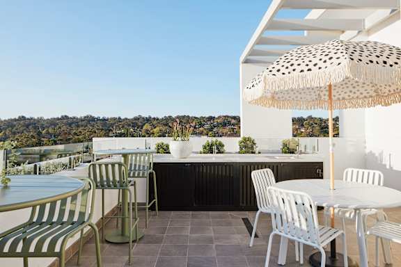 a roof terrace with tables and chairs and a bar