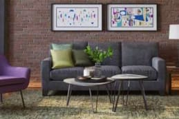 a living room with a couch and chairs and a table