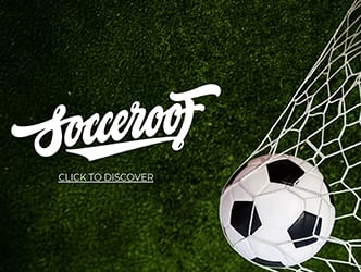 A soccer ball is in front of a soccer goal net.