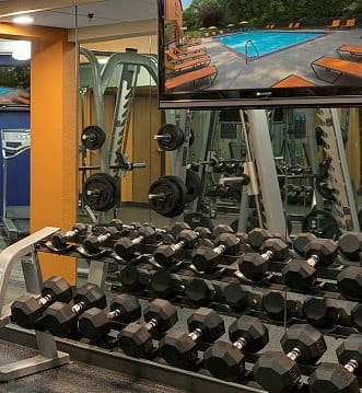 a gym with a bunch of dumbbells on the floor  at Park Pointe, St. Louis Park, Minnesota