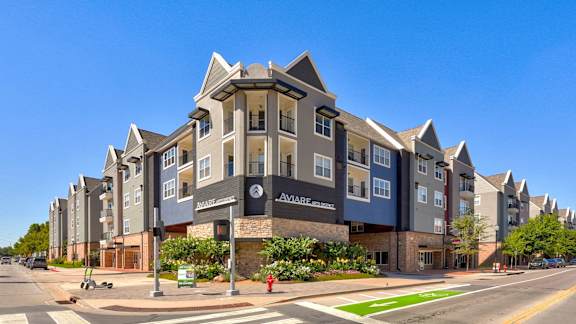 an apartment building on the corner of a city street