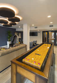 A modern kitchen with a dining table and chairs.