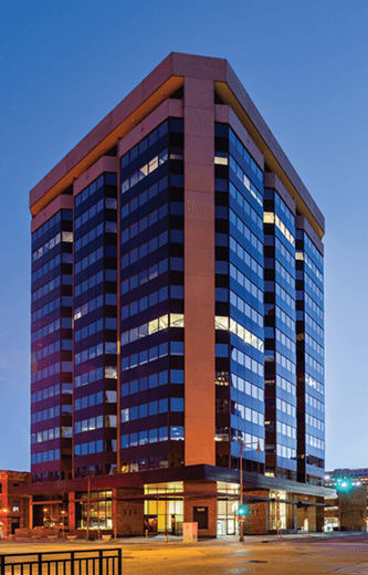A tall building with many windows is shown in the image.