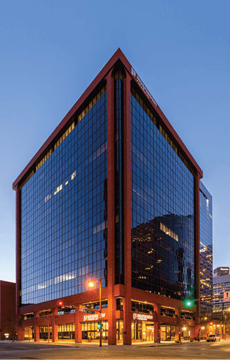 A tall building with a red frame and blue glass windows.