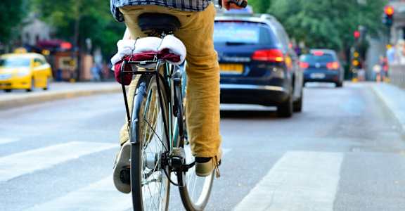 A person is riding a bicycle on a city street.