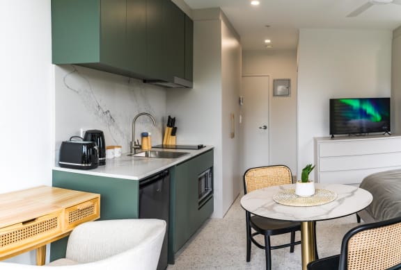 a kitchen and dining area with a table and chairs