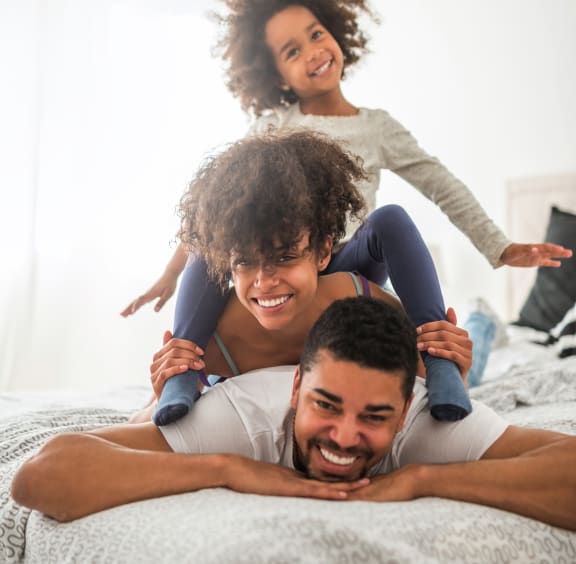 a man laying on a bed with two children