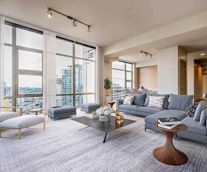 A modern living room with a grey sofa and a coffee table.