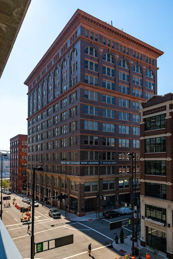 a tall brick building with a street in front of it