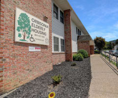 a brick building with a sign that says onondaga elderly housing