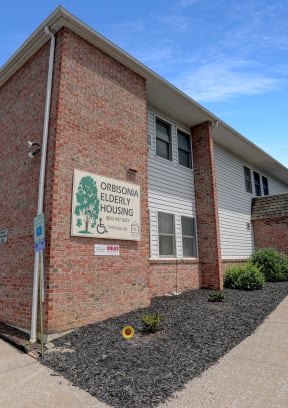 a brick building with a white sign on it