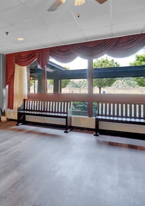 a living room with a fireplace and a large window