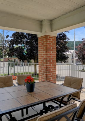 Apartments in Three Springs | Three Springs Estates | a patio with a table and  a potted plant on it