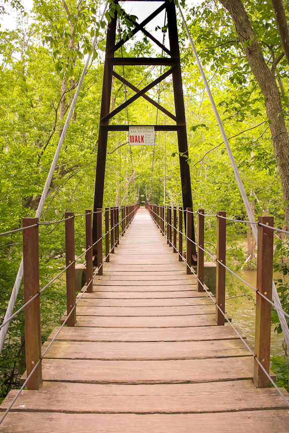 A wooden walkway leads to a sign that says "Walk".