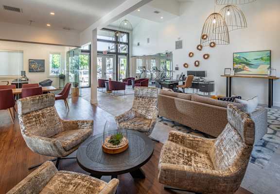 a living room with couches and chairs and a table