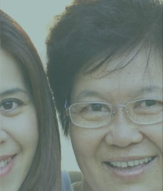 A man and a woman are smiling at the camera.