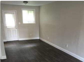 a large empty room with a wooden floor