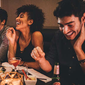 A group of people are enjoying a meal together at a restaurant.