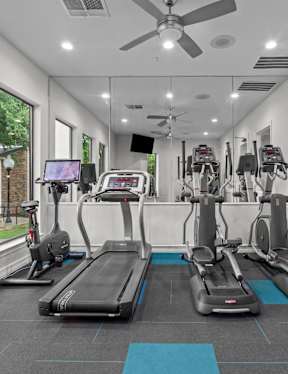 A gym with treadmills and exercise bikes.