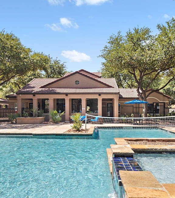 A swimming pool with a house in the background.