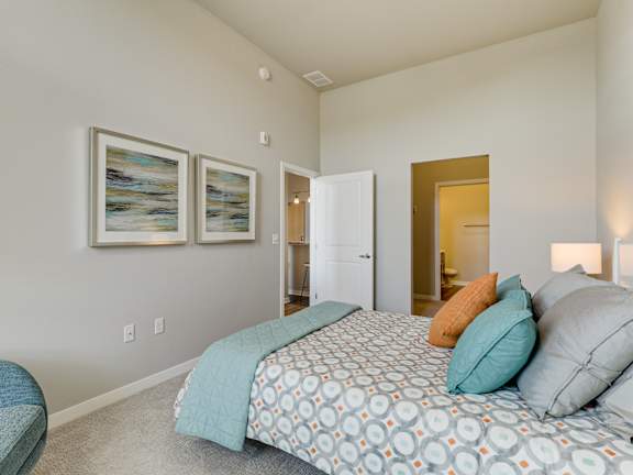 a bedroom with a bed and two pillows on it