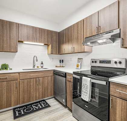 a kitchen with wooden cabinets and a stove and a sink