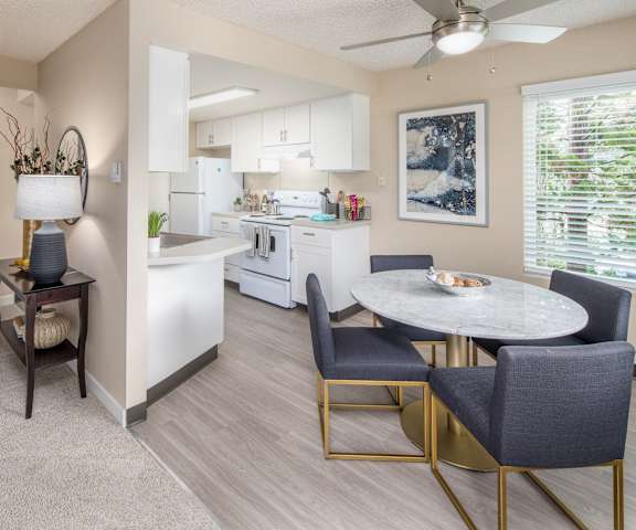 an open kitchen and dining room with a table and chairs