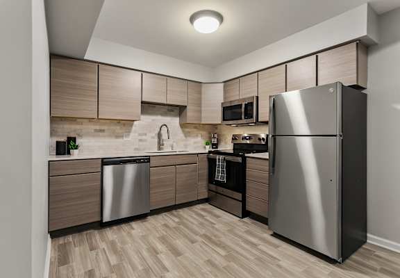 a kitchen with stainless steel appliances and wooden cabinets