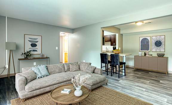 A living room with a grey couch and a coffee table.