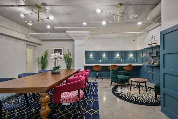A conference room with a long table and chairs.