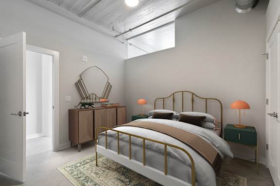 A bedroom with a bed, nightstand, and lamp.