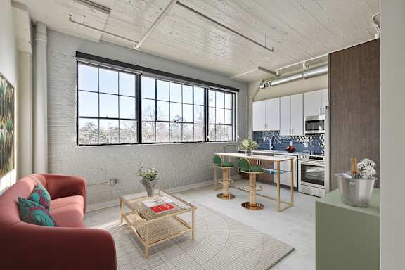 A living room with a red chair and a wooden coffee table.