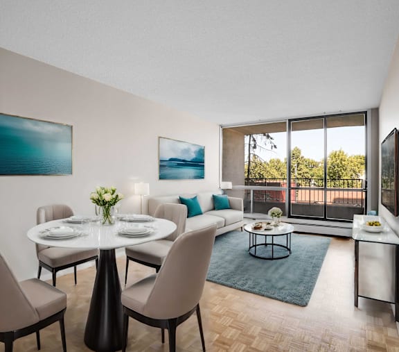 A dining room with a table set for four and a view of the backyard.