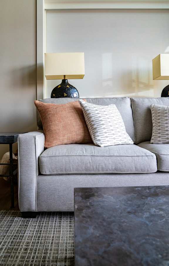 a living room with a couch and pillows on it
