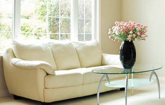 a living room with a couch a table and a window