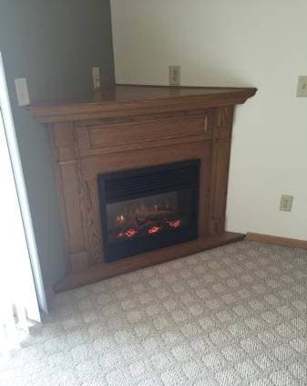 a fireplace with a wooden mantle in a living room