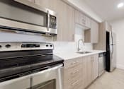 Thumbnail 18 of 23 - Electric Range In Kitchen at Avia Lofts at Maple Road, Amherst, 14221