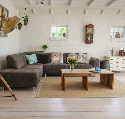 A living room with a grey couch and a wooden coffee table.