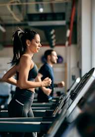 woman running on a treadmill at the gym at Platinum Castle Hills, Lewisville, Texas